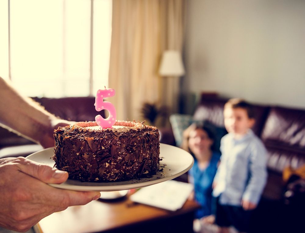 Family celebrate birthday party with chocolate cake