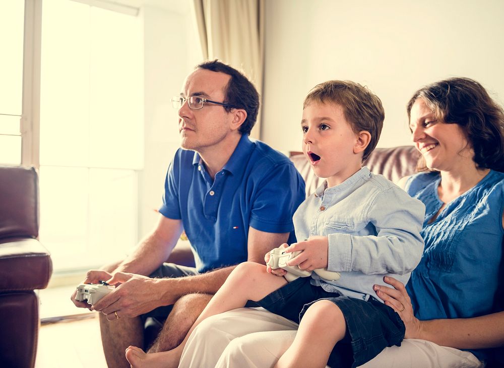 Family playing video game together on weekend holiday