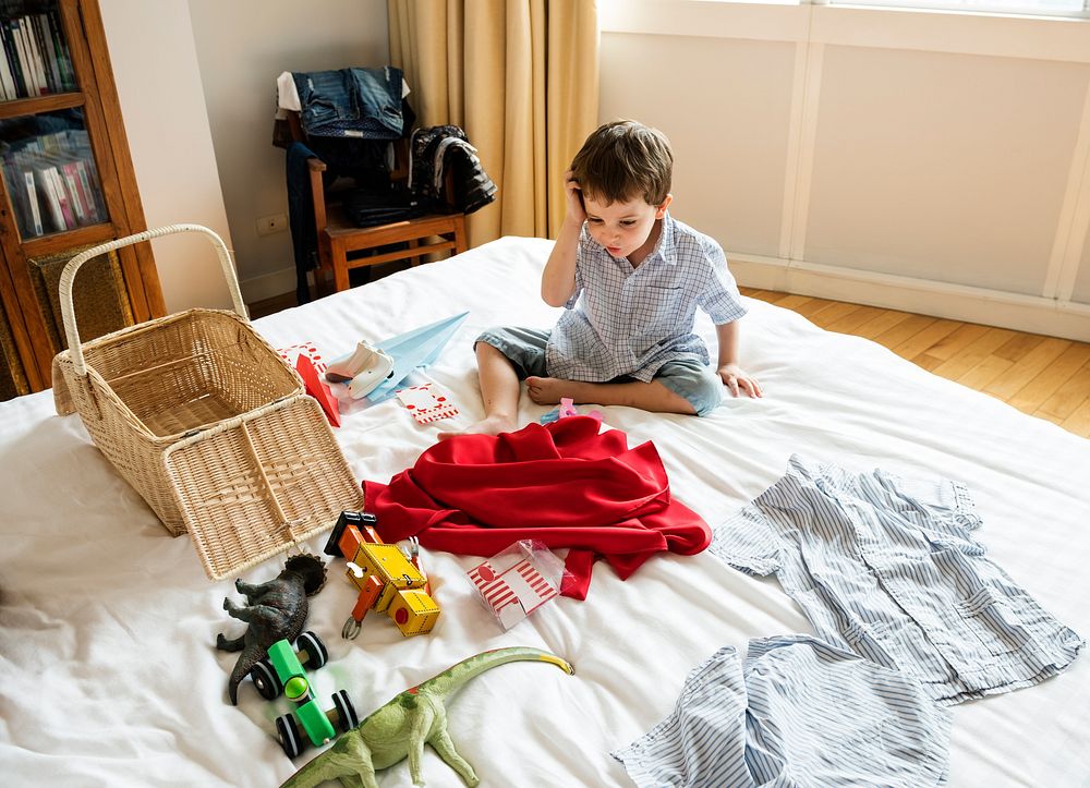 A boy looking at superhero costume in a bedroom