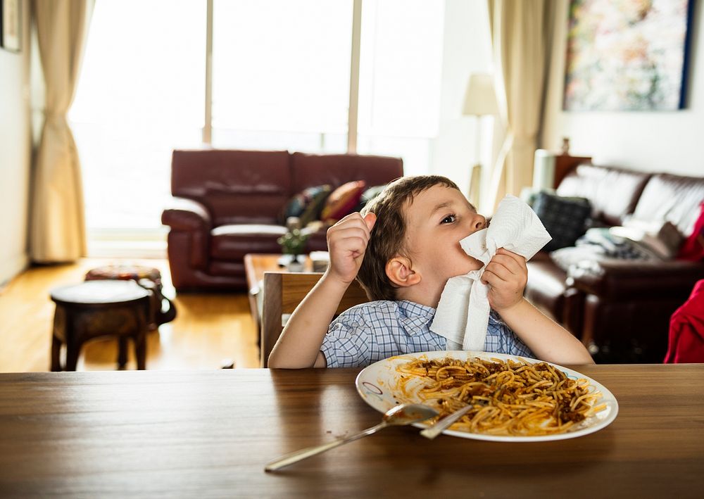 Boy eating a plate of spaghetti
