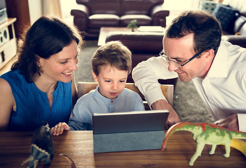 Mom Dad and Son Watching Tablet Spend Time Holiday Together