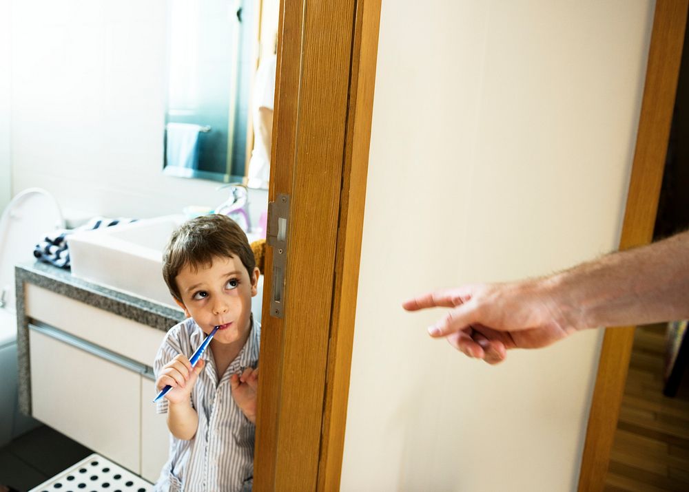 Naughty boy brushing his teeth