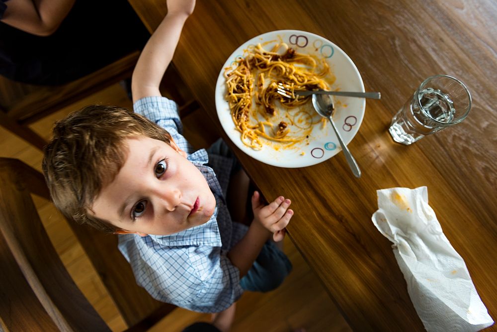 Boy eating spaghetti
