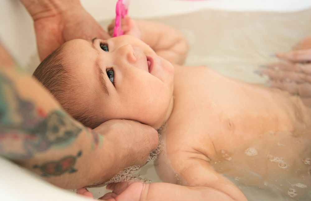 Closeup of baby taking a bath in the tub