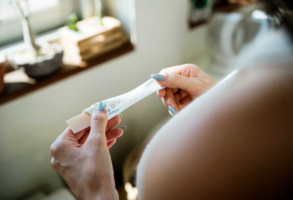 closeup of woman hands holding pregnancy test