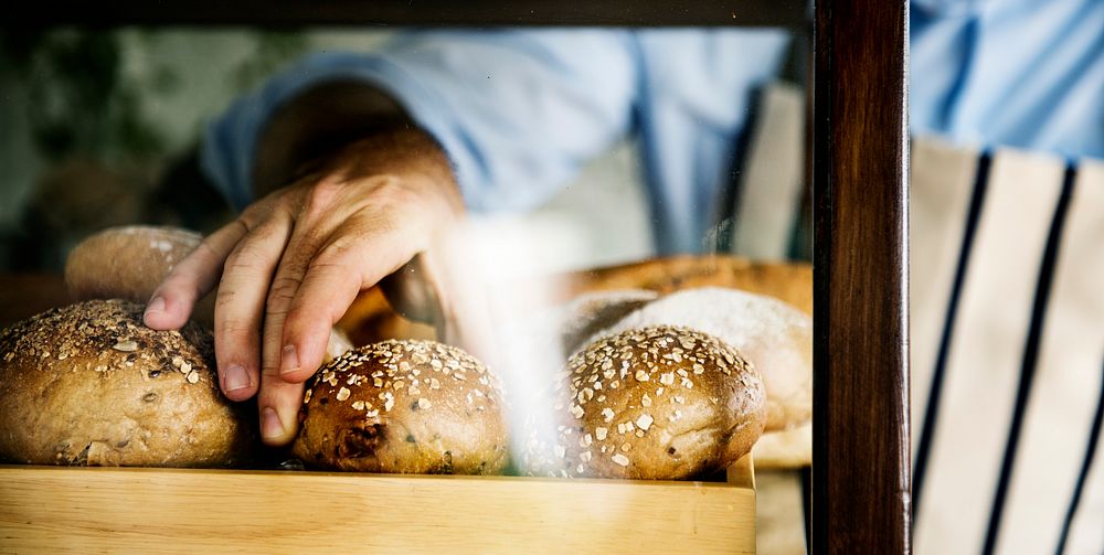 Man Hand Picking Baked Bread