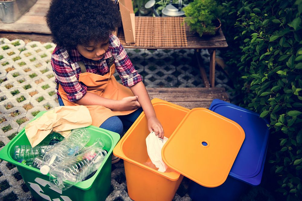 African Descent Kid Separating Recyclable Trash