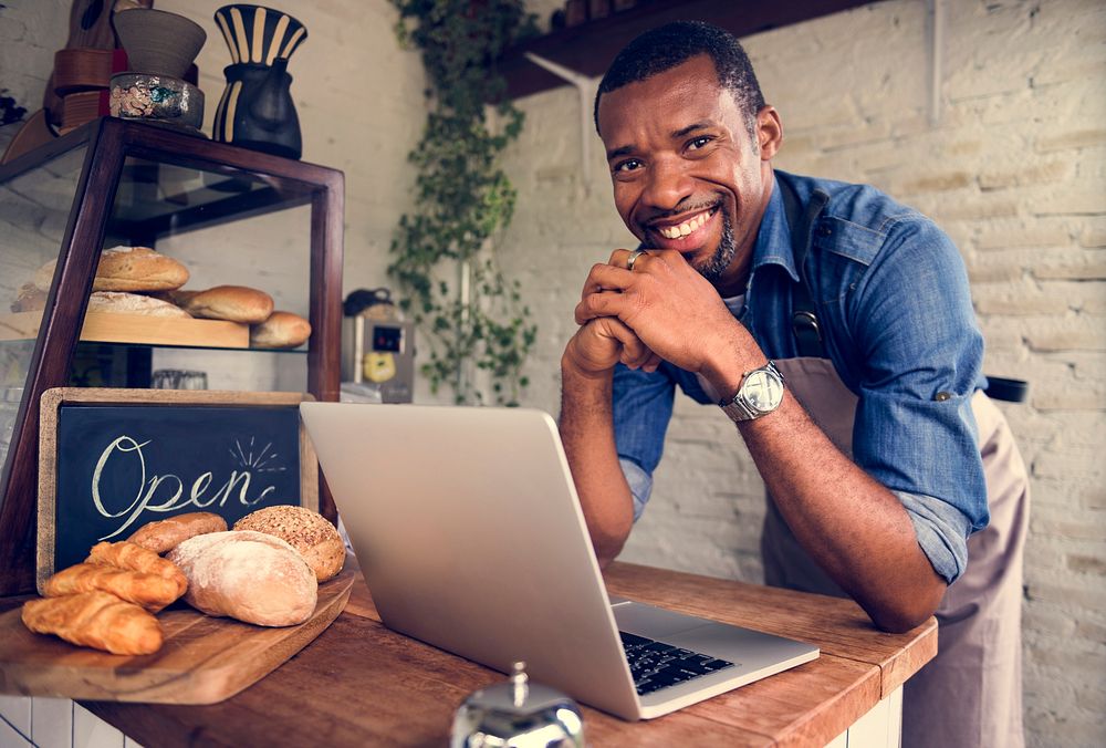 Man using devices for online business order at bakehouse