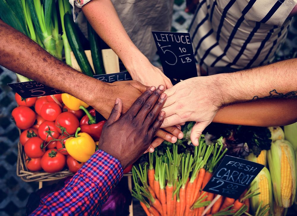 Hands stack for support power at grocery shio