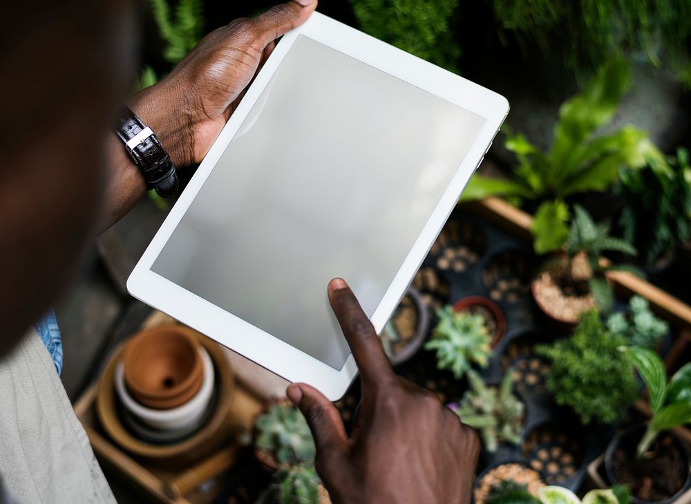 Gardening man using an empty screen tablet