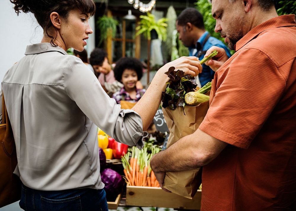 People Buying Vegetable From Shop at Market