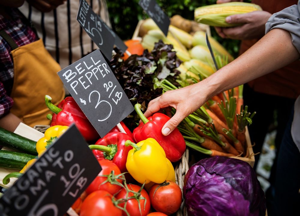 People Buying Vegetable From Shop at Market