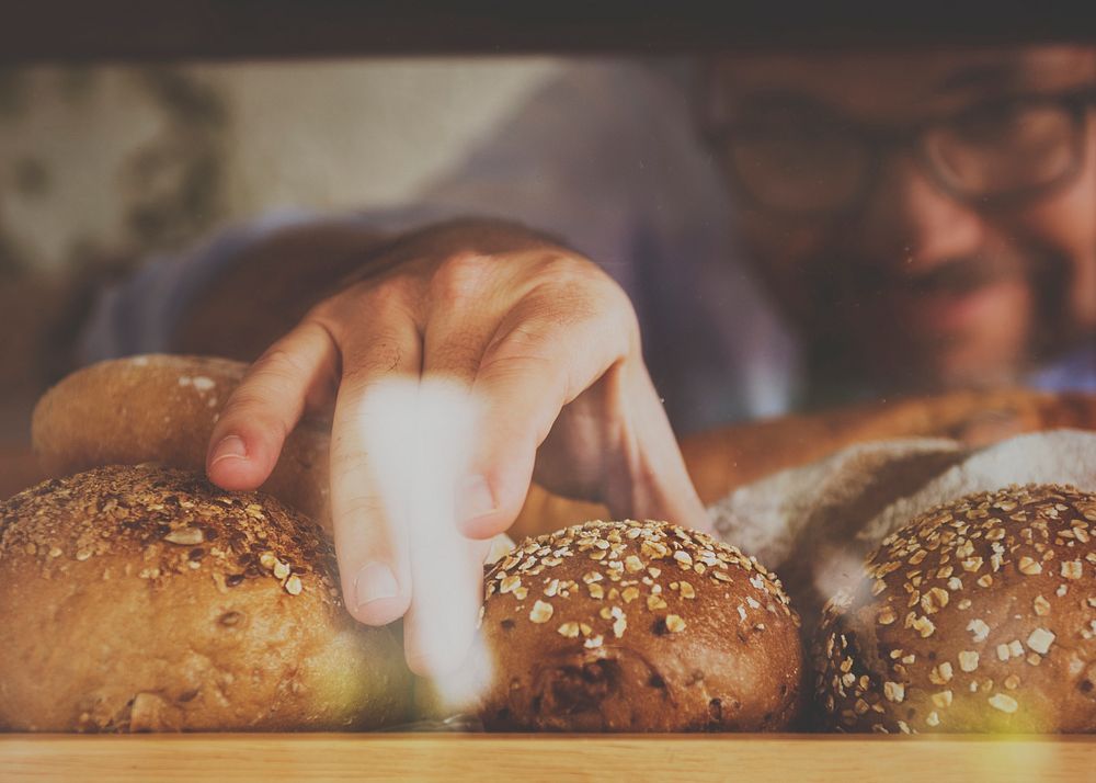 Closeup of hand grabbing bread