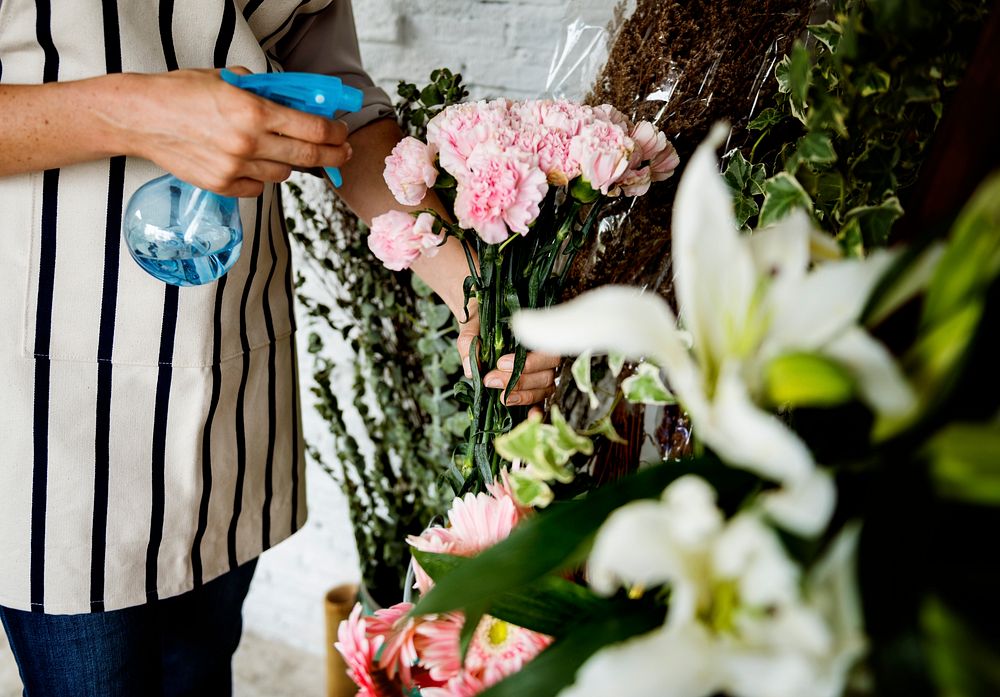 Woman Spraying Flowers to Refreshing in Flora Shop
