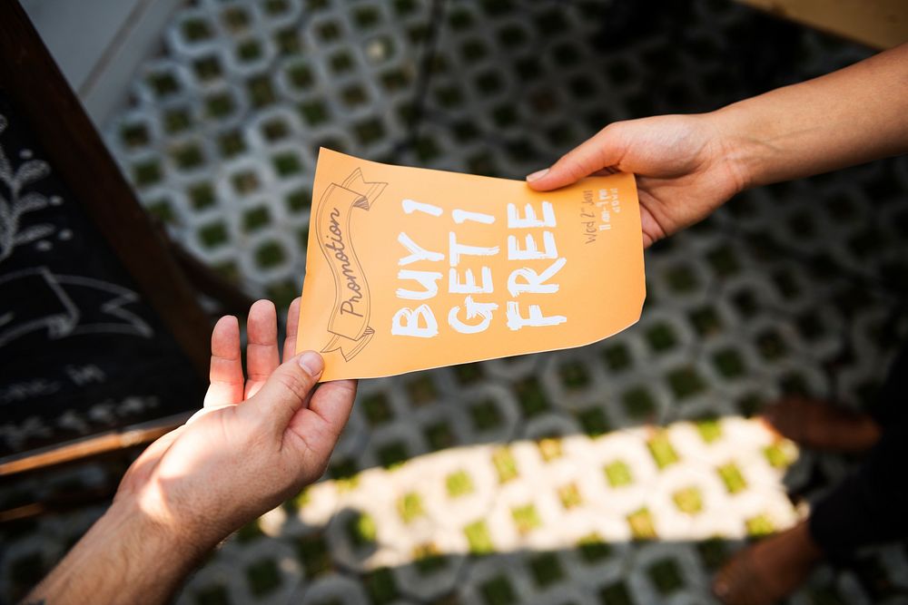 People Handing Out Promotion Brochure to Customer