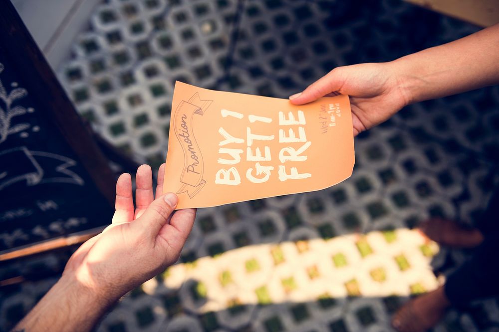 People Handing Out Promotion Brochure to Customer