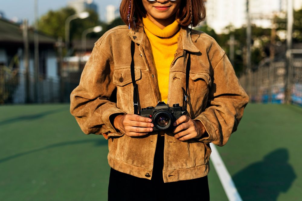 Girl smiling while holding a camera