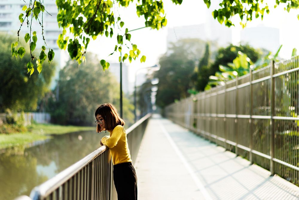 Girl looking at the river over the railing