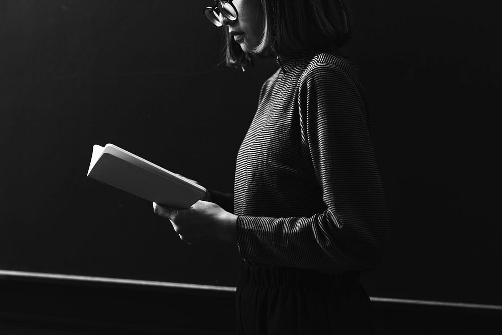 Grayscale girl reading a book