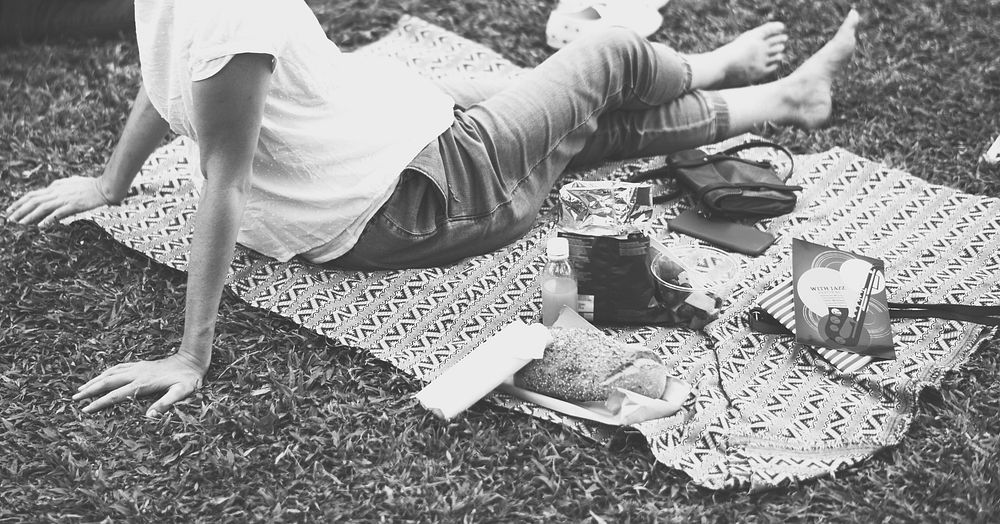 An Adult Woman Sitting and Picnicking in The Park