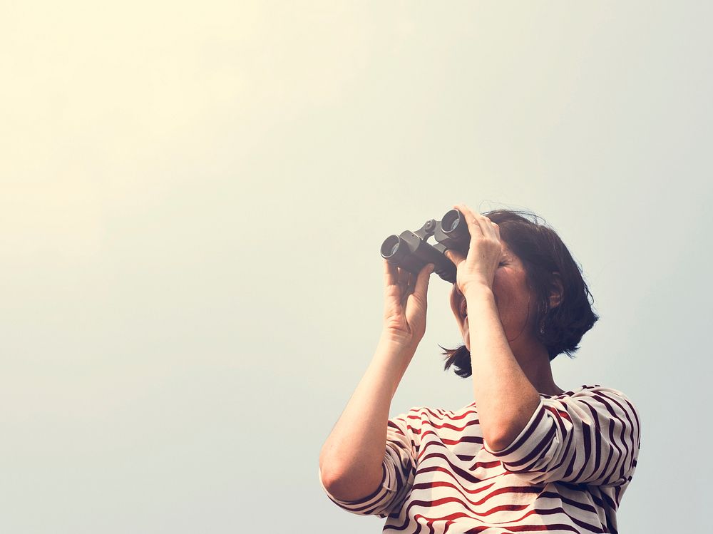 Woman using binocular explore searching