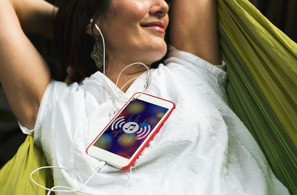 Adult Woman Listening Music With Mobile Phone on Hammock