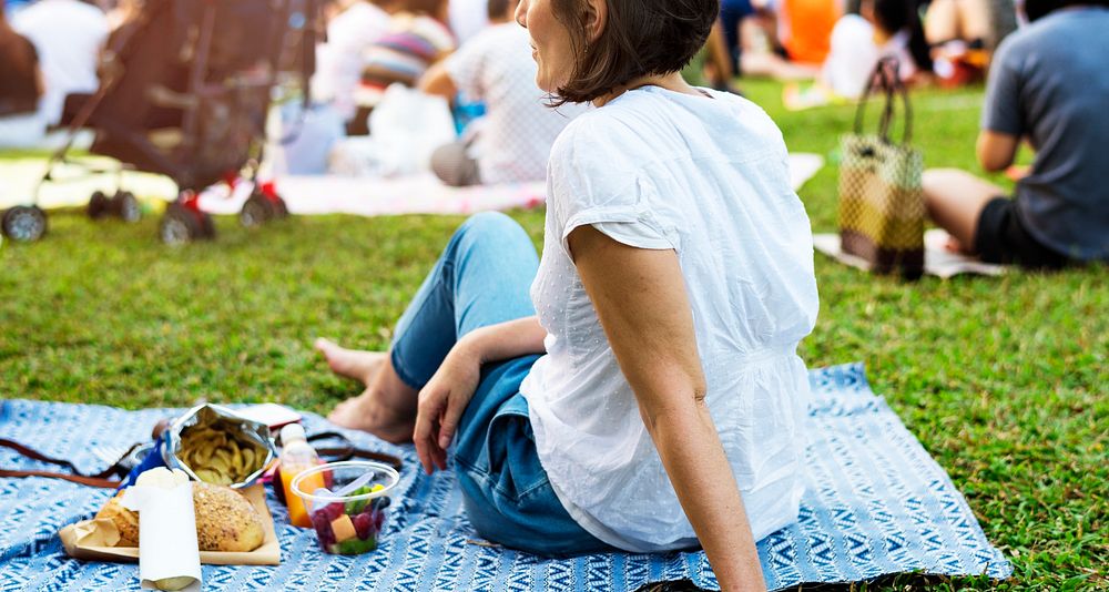 An Adult Woman Sitting and Picnicking in The Park