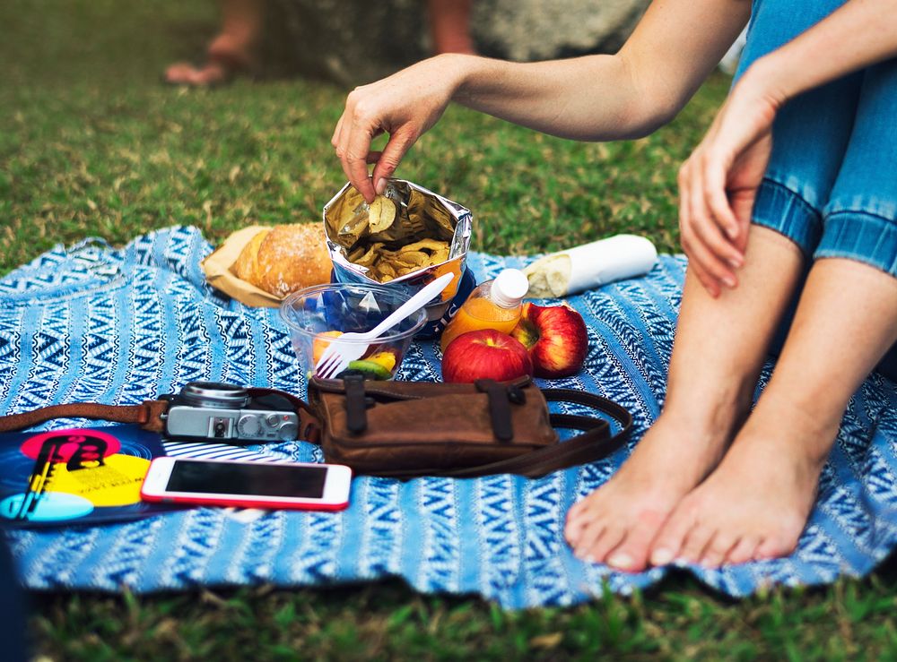 Woman eating snack picnic at park