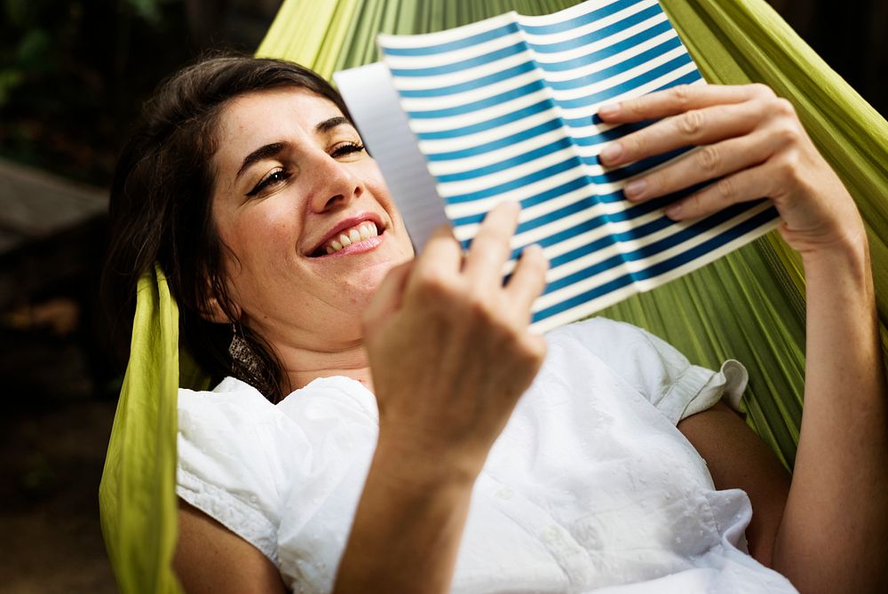 An Adult Woman Reading Book on a Hammock