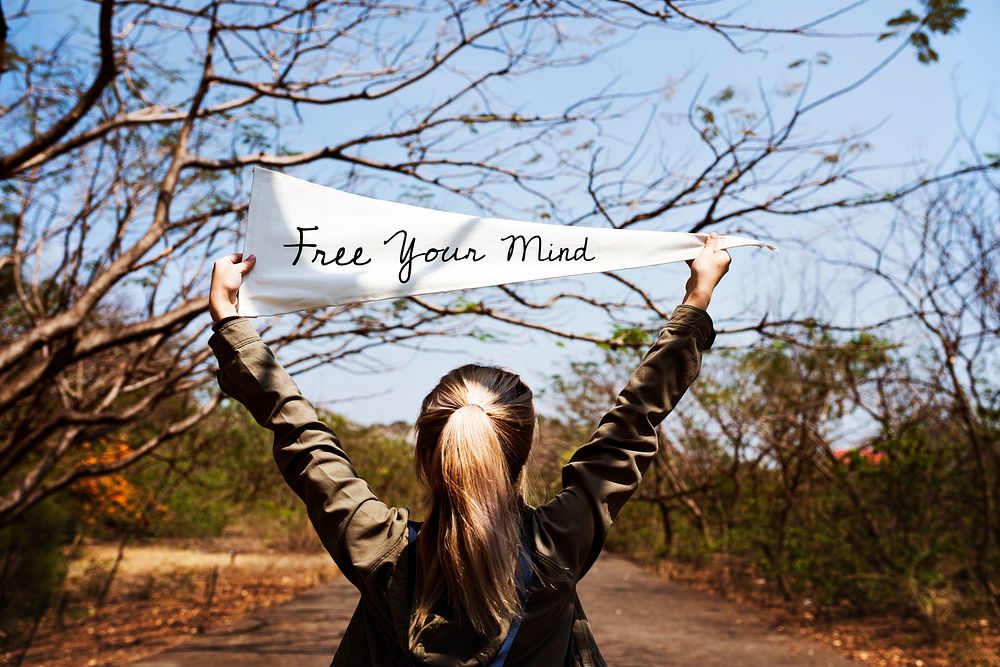 Girl holding free your mind flag banner