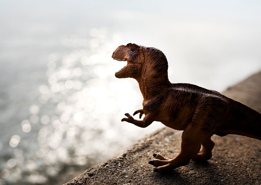 Tyrannosaurus rex jurassic figure toy in the river