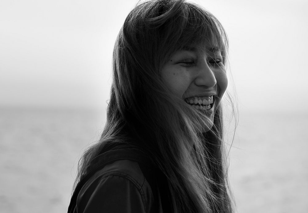 Asian woman smiling with eyes closed portrait