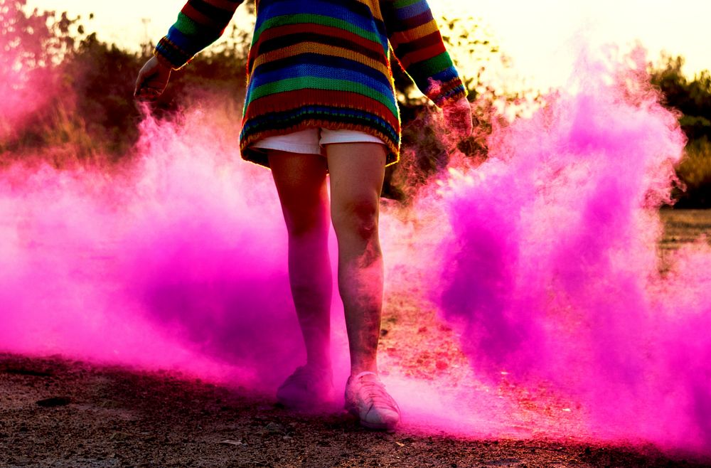 Person having fun with pink powder
