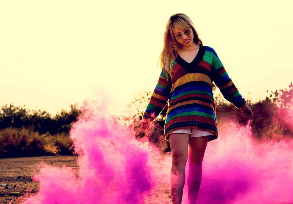 Woman Hands Holding Pink Smoke Bomb Outdoors