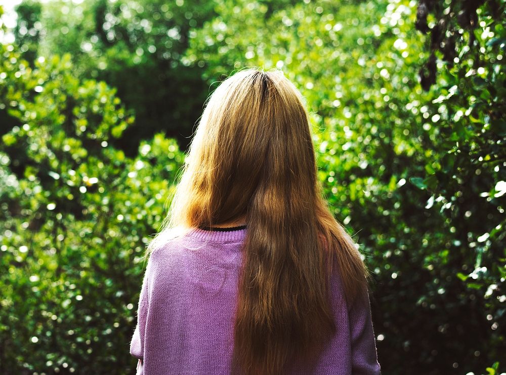 Rear view of woman with long hair in the garden