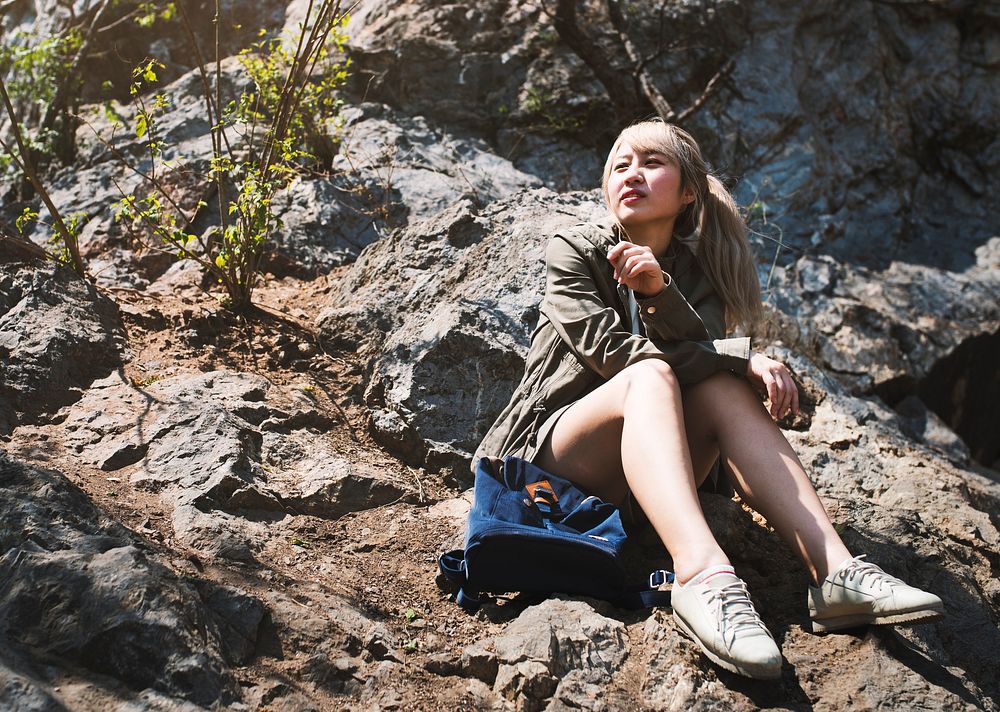 Woman resting sitting on rocks