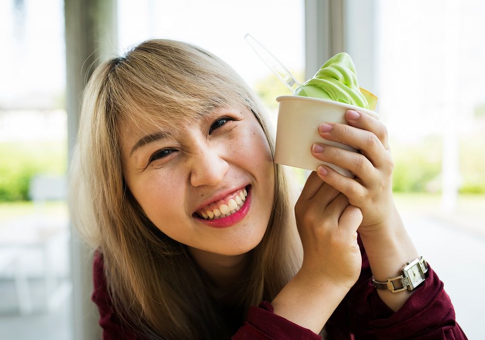 Woman eating melon ice-cream in a cup