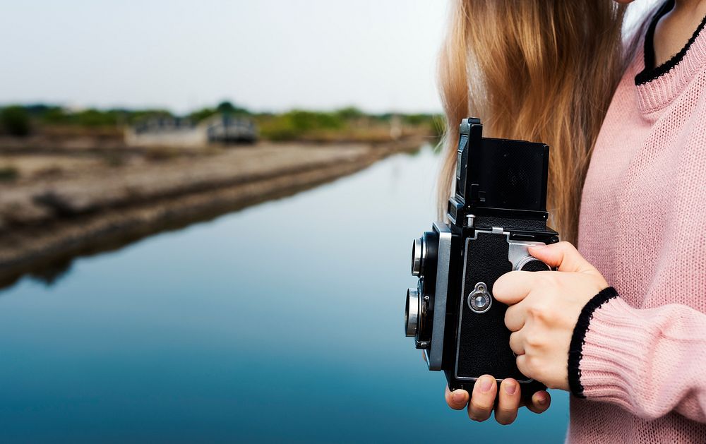 Girl using a vintage camera outdoors