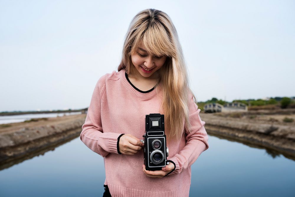 Girl using a vintage camera outdoors