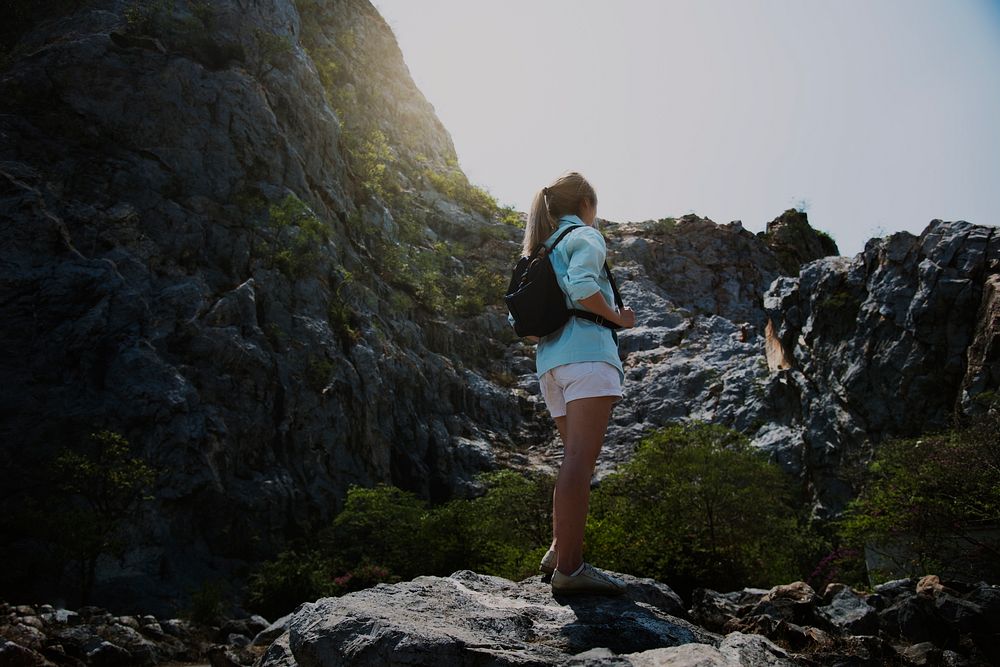 Young woman trekking on a rock mountain