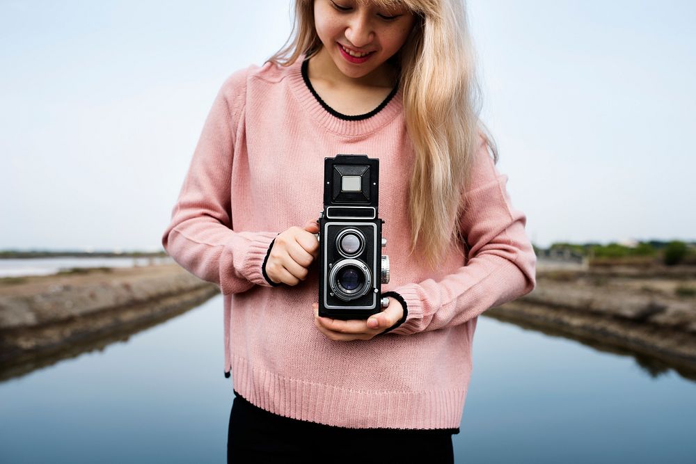 Woman wanderlust with vintage retro camera