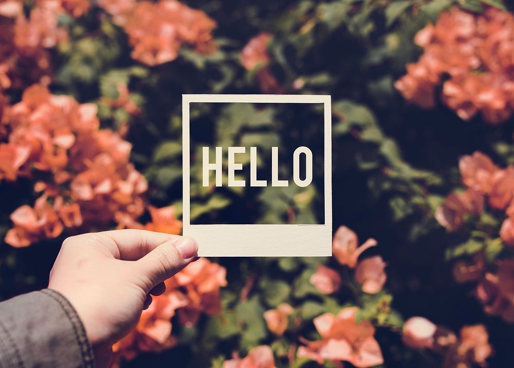 People Hand Holding Hello Photo Frame with Bougainvillea Backgro