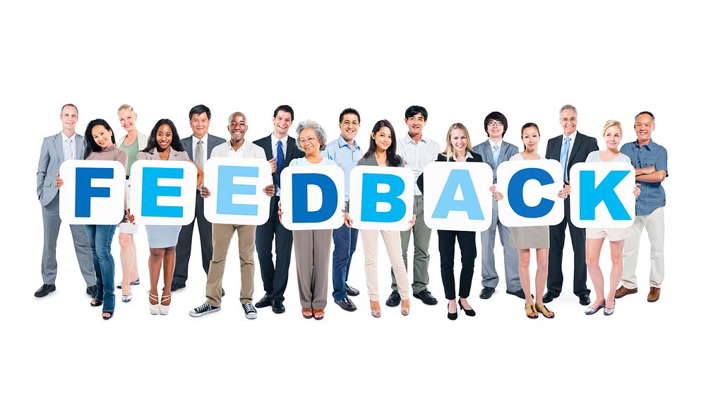 Group Of Happy Multi-Ethnic Business People Holding The Word Feedback