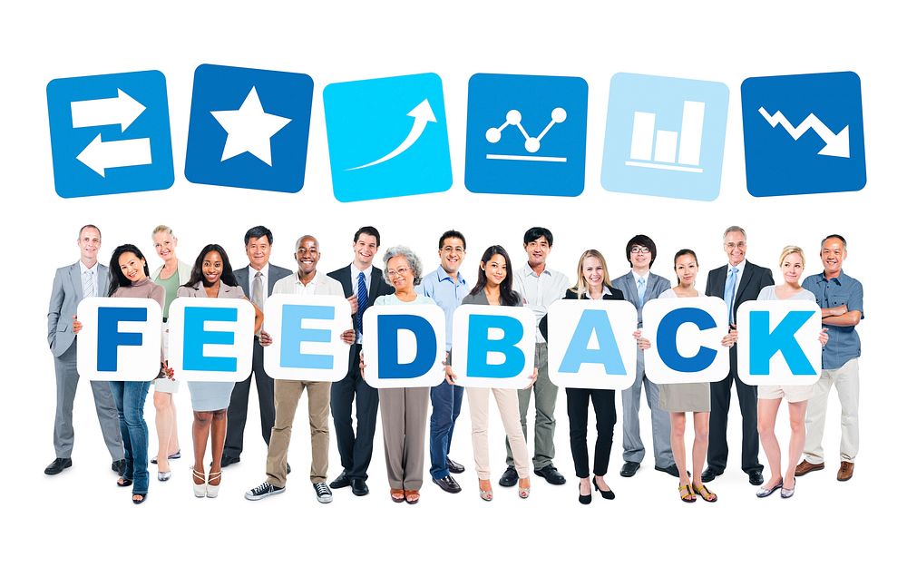 Multi-ethnic group of business and casual people holding cardboards forming feedback.