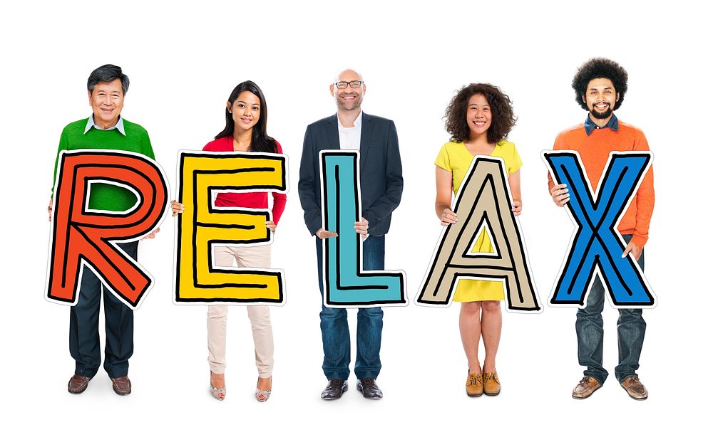 Diverse Group of People Holding Text Relax