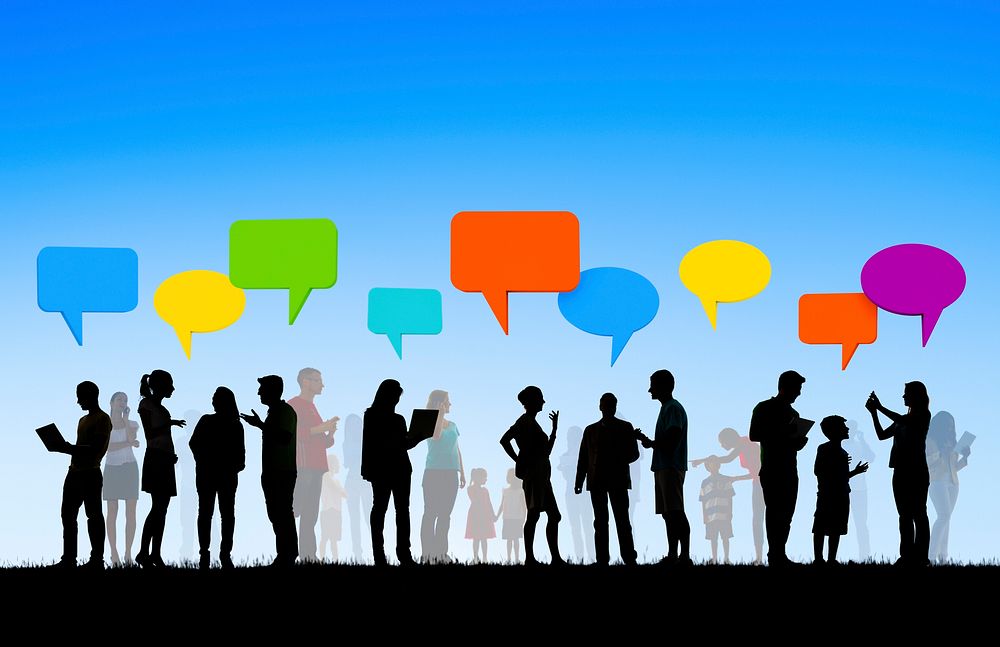 Group Of Multi-Ethnic People Social Networking Outdoors And Colorful Empty Speech Bubbles Above