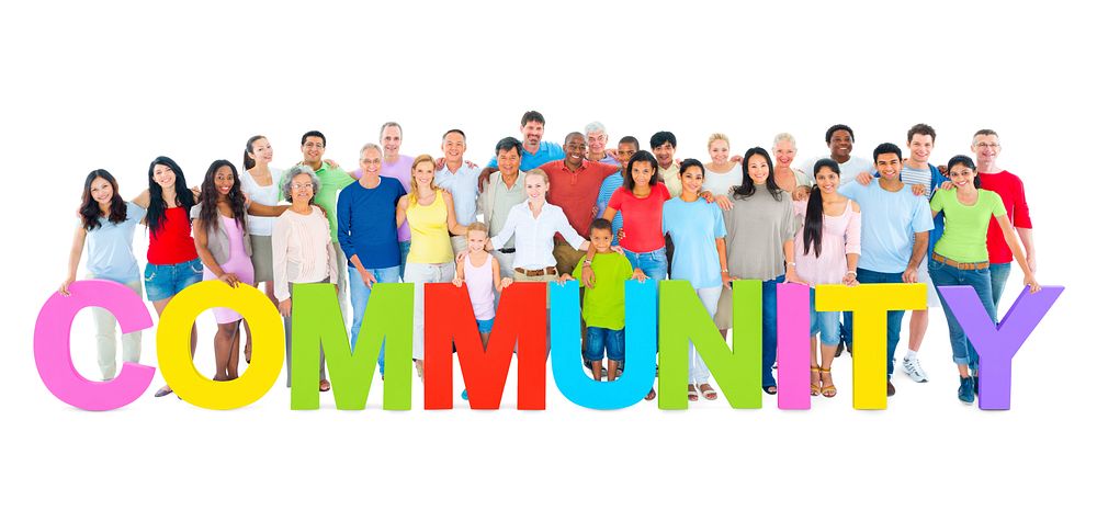Multi-ethnic group of people holding "COMMUNITY" letters