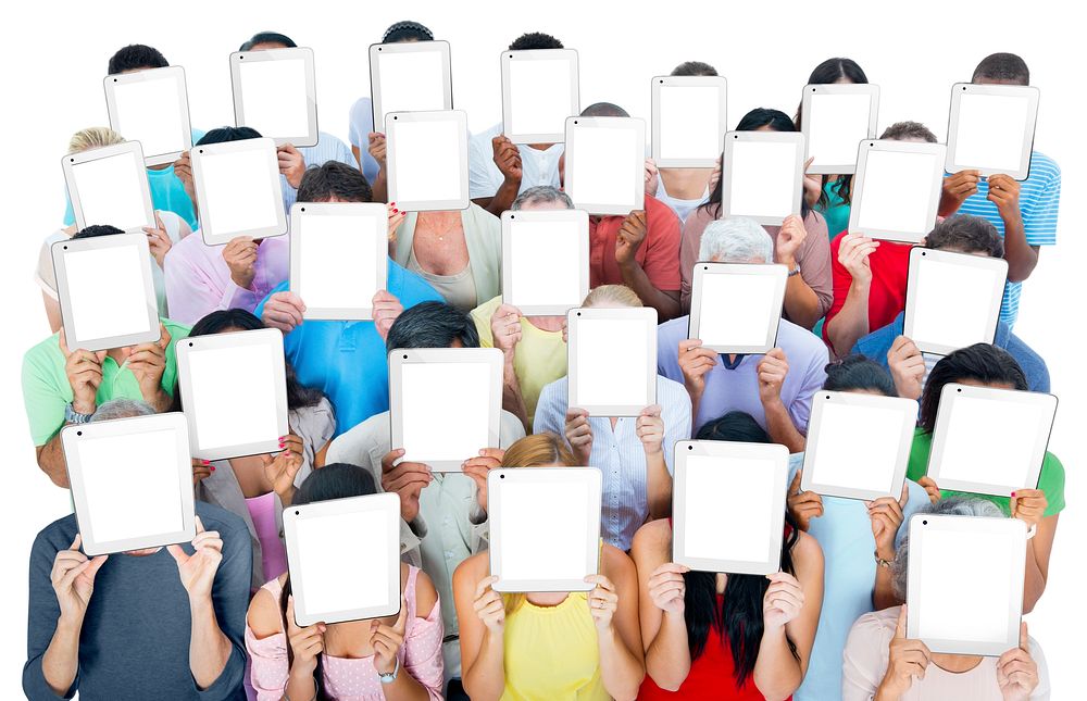 Multi-ethnic casual people holding tablets covering there faces.