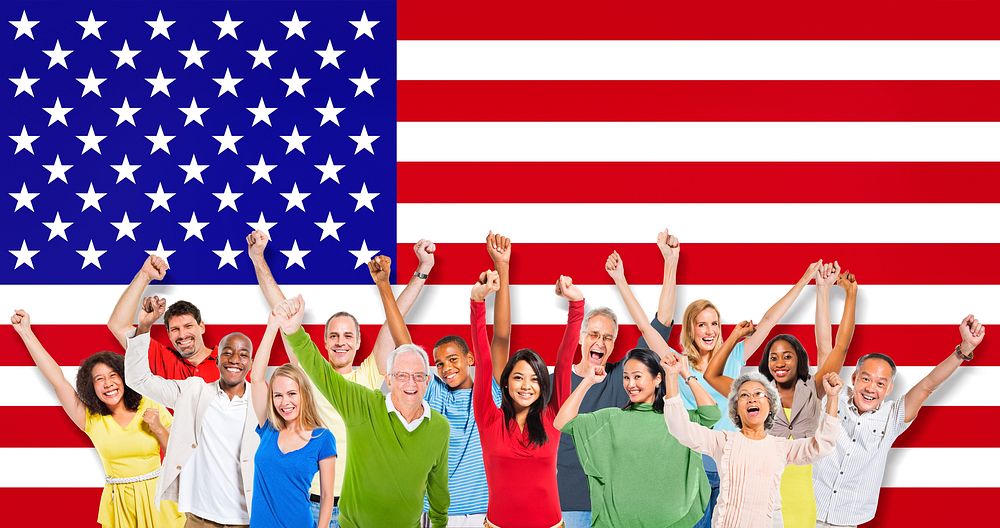 Multi-Ethnic Group Of People Raising Their Arms With American Flag As A Background