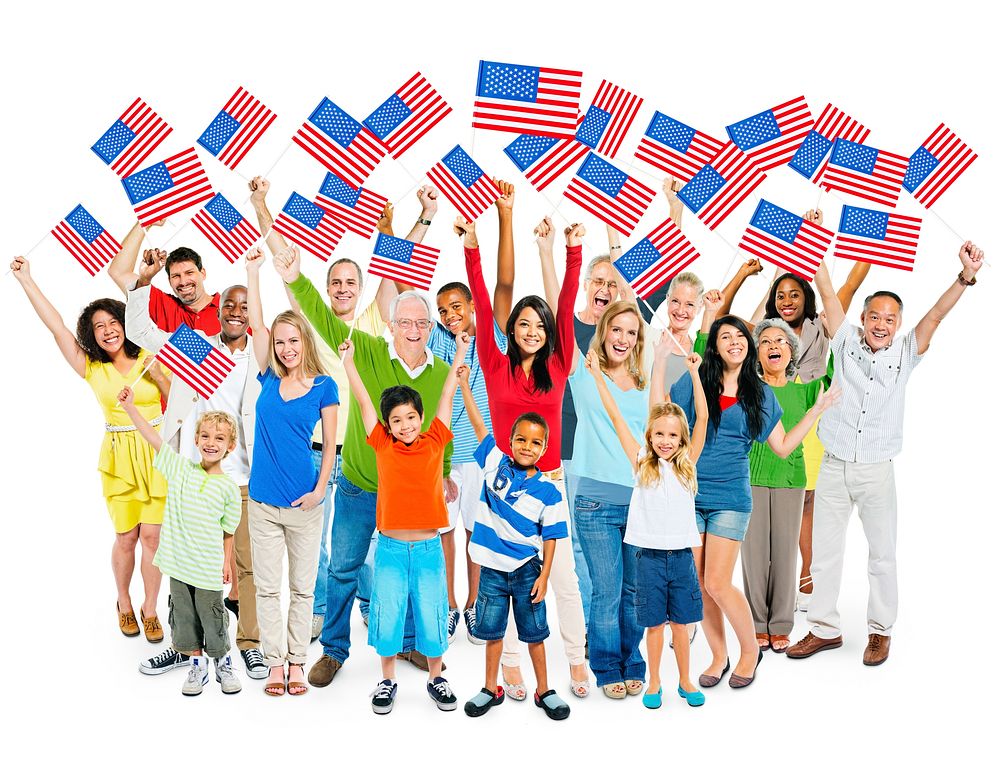 Cheerful Multi-Ethnic Group Of People Standing With Their Arms Raised Holding American Flag.